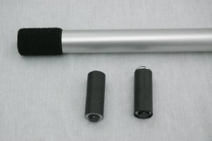 One end of the lenzs law tube, one dummy magnet and one real magnet (both look the same) on a white background.