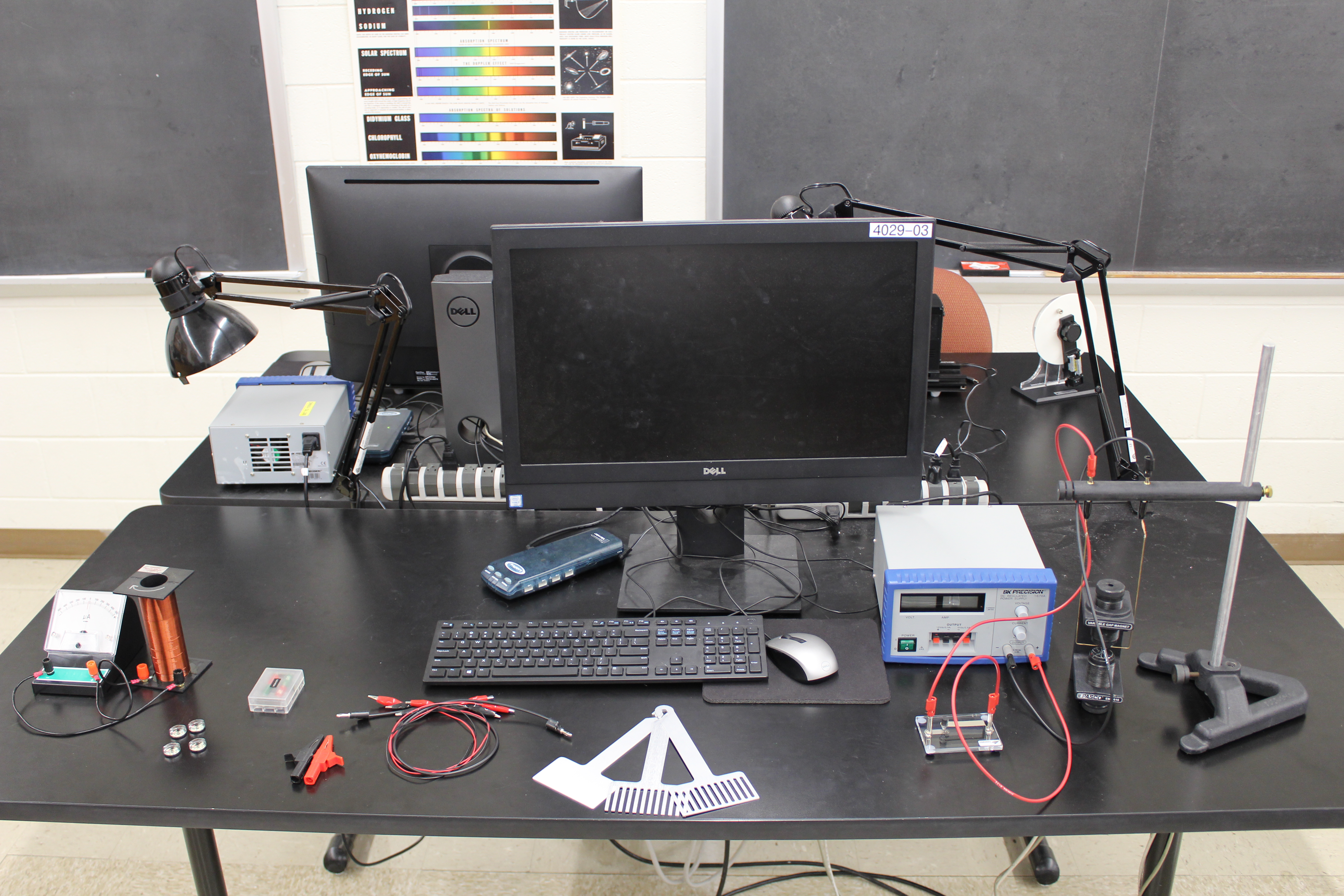 Whole Table Setup of the Magnetic Fields Lab. Galvanometer and Solenoid on the left, Trapeze Setup on the right connected to the power supply. Other Accessories are spread from left to right.