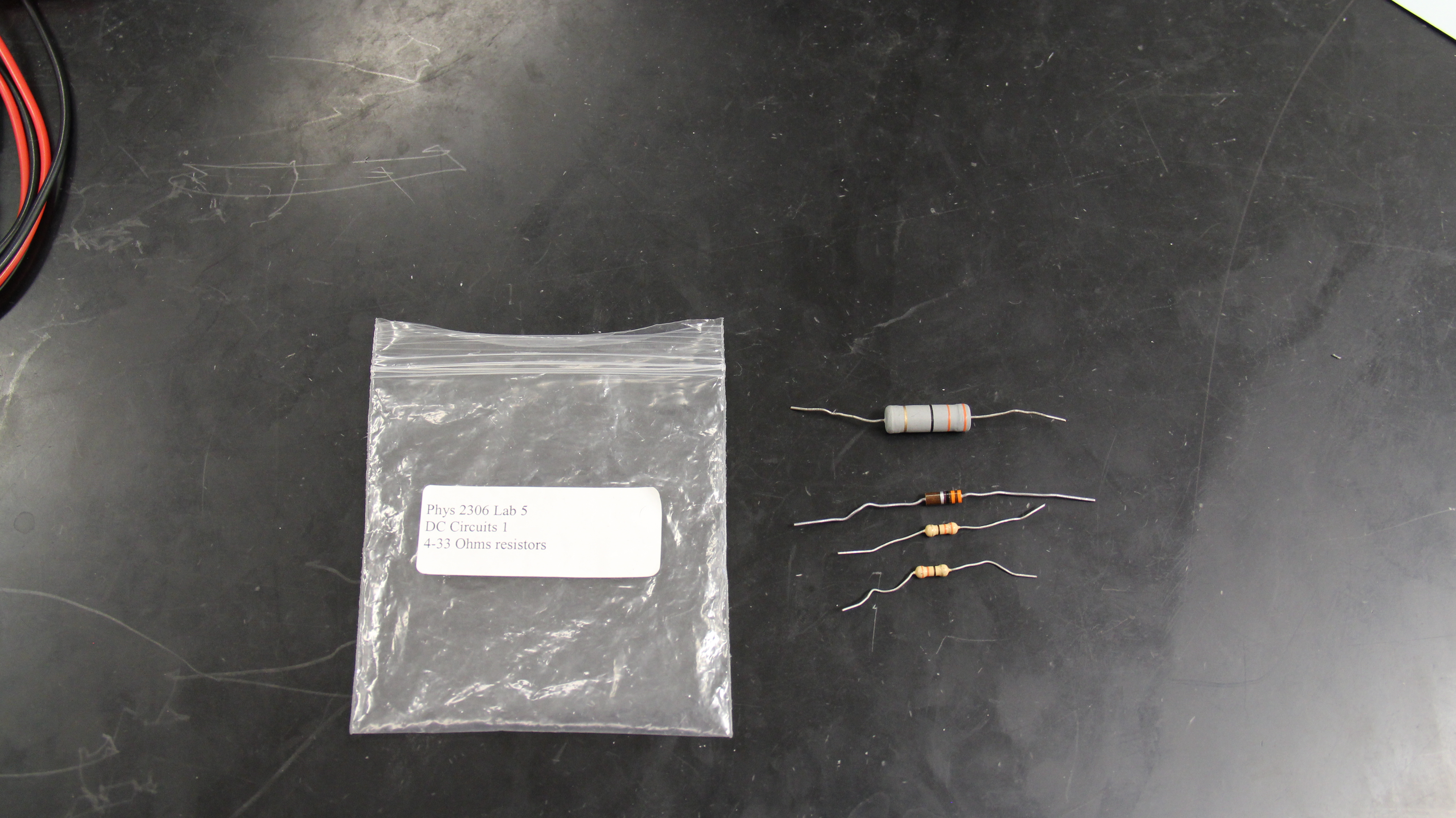The resistors and the bag in which they are stored lying on a table. Multiple styles of the same resistor are shown.